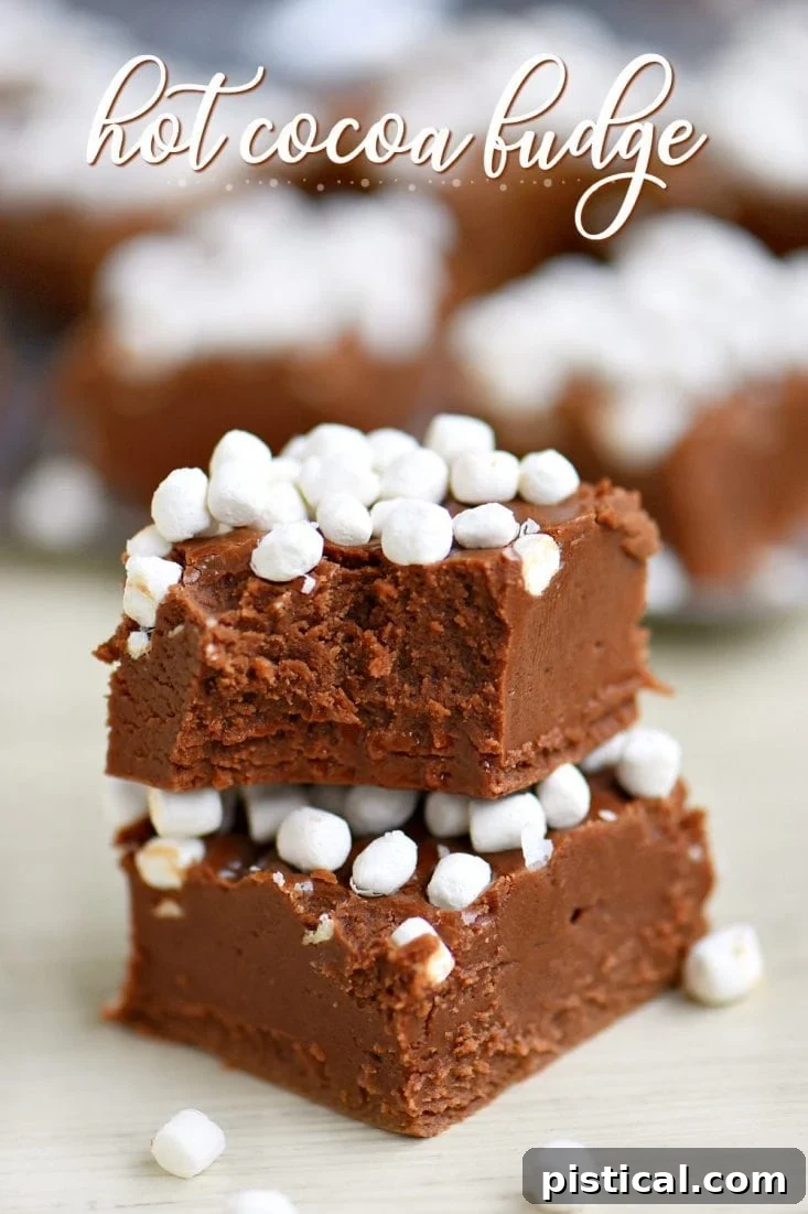 Decadent Hot Cocoa Fudge with Mini Marshmallows Rich, creamy hot cocoa fudge topped with mini marshmallows, cut into perfect squares.