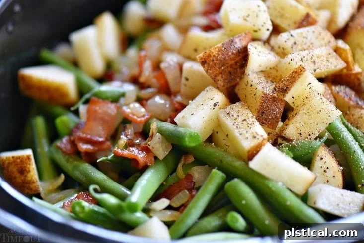 Fresh ingredients for Slow Cooker Green Beans with Bacon laid out: green beans, bacon, potatoes, onion, broth
