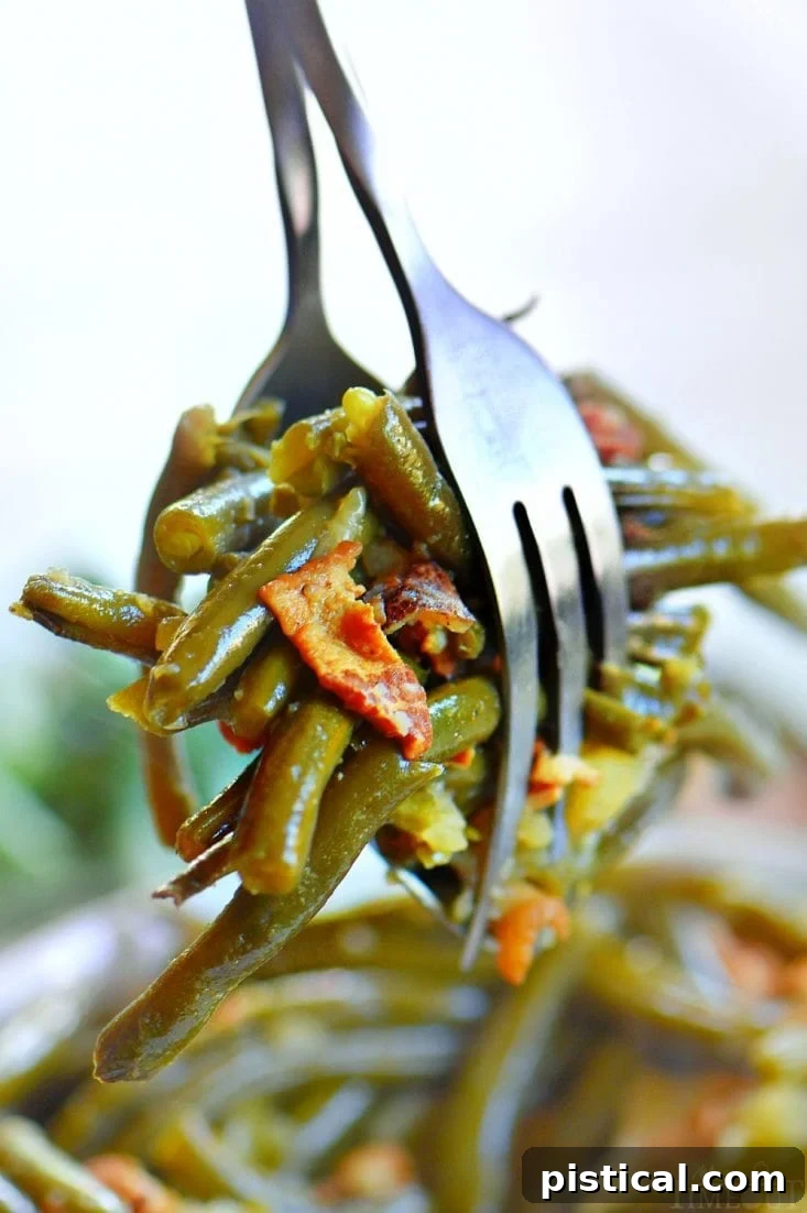 Close-up of tender Crockpot Green Beans with Bacon and potatoes, served in a bowl