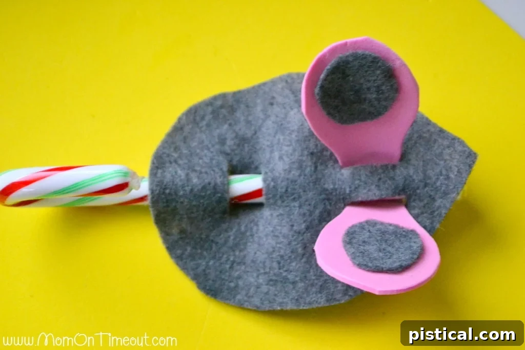 Candy Cane Mice Step 5 Step-by-step instructions for Candy Cane Christmas Mice: Gluing inner ears, sliding ears into slits, and inserting the candy cane.