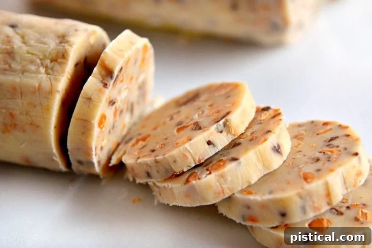 Sliced butterscotch shortbread cookie dough on a cutting board, ready for baking