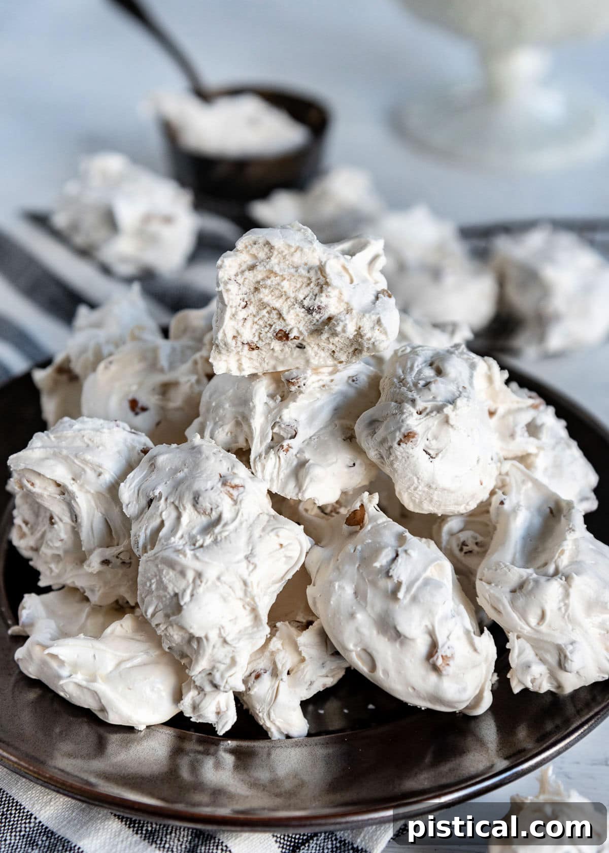 silver plate topped with lots of divinity candy piled high. top piece of divinity is broken in half.