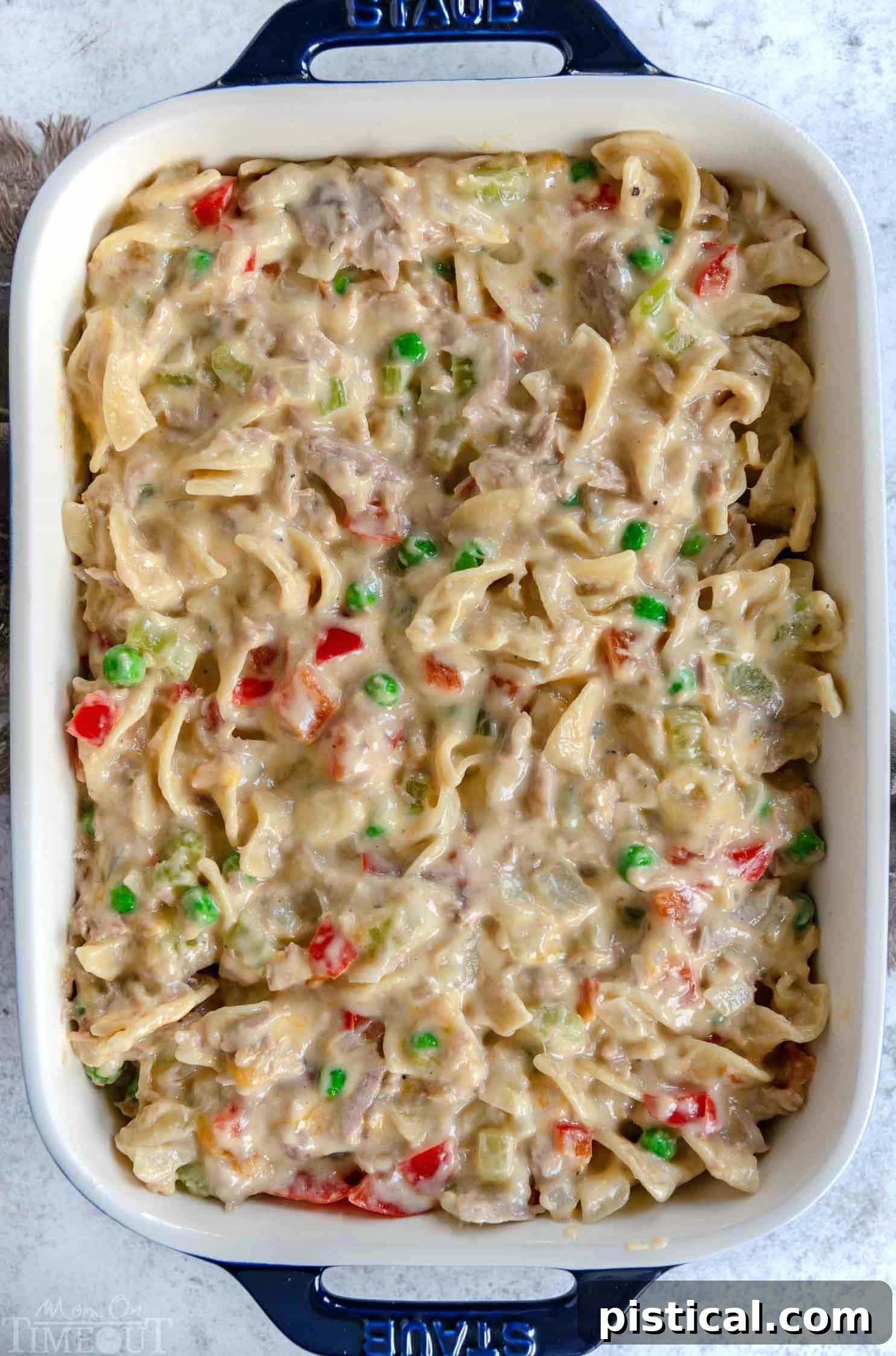 Creamy tuna casserole in a white baking dish, showcasing its rich texture before serving.