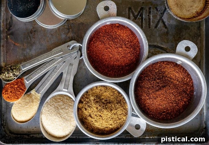 The Fresh Components of Homemade Taco Seasoning Individual ingredients for homemade taco seasoning, measured out in spoons and cups, highlighting the fresh and natural components of the blend.