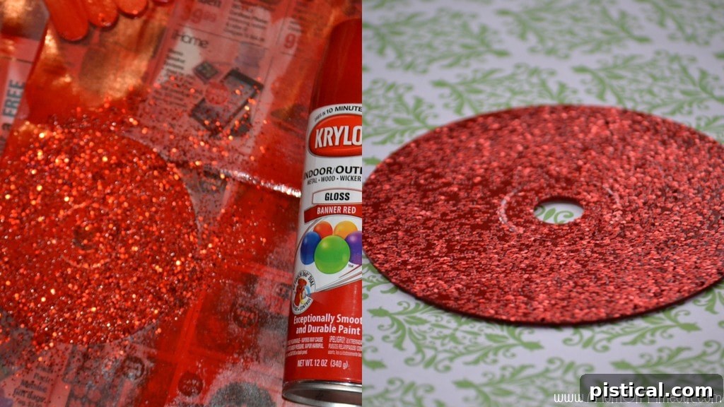 Close-up of a CD being spray painted red with glitter, the first step in making a candy cane wreath.