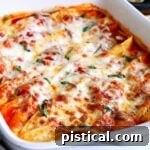 Effortless Baked Shells 2 Baked stuffed shells topped with fresh basil and melted cheese, ready to be served.