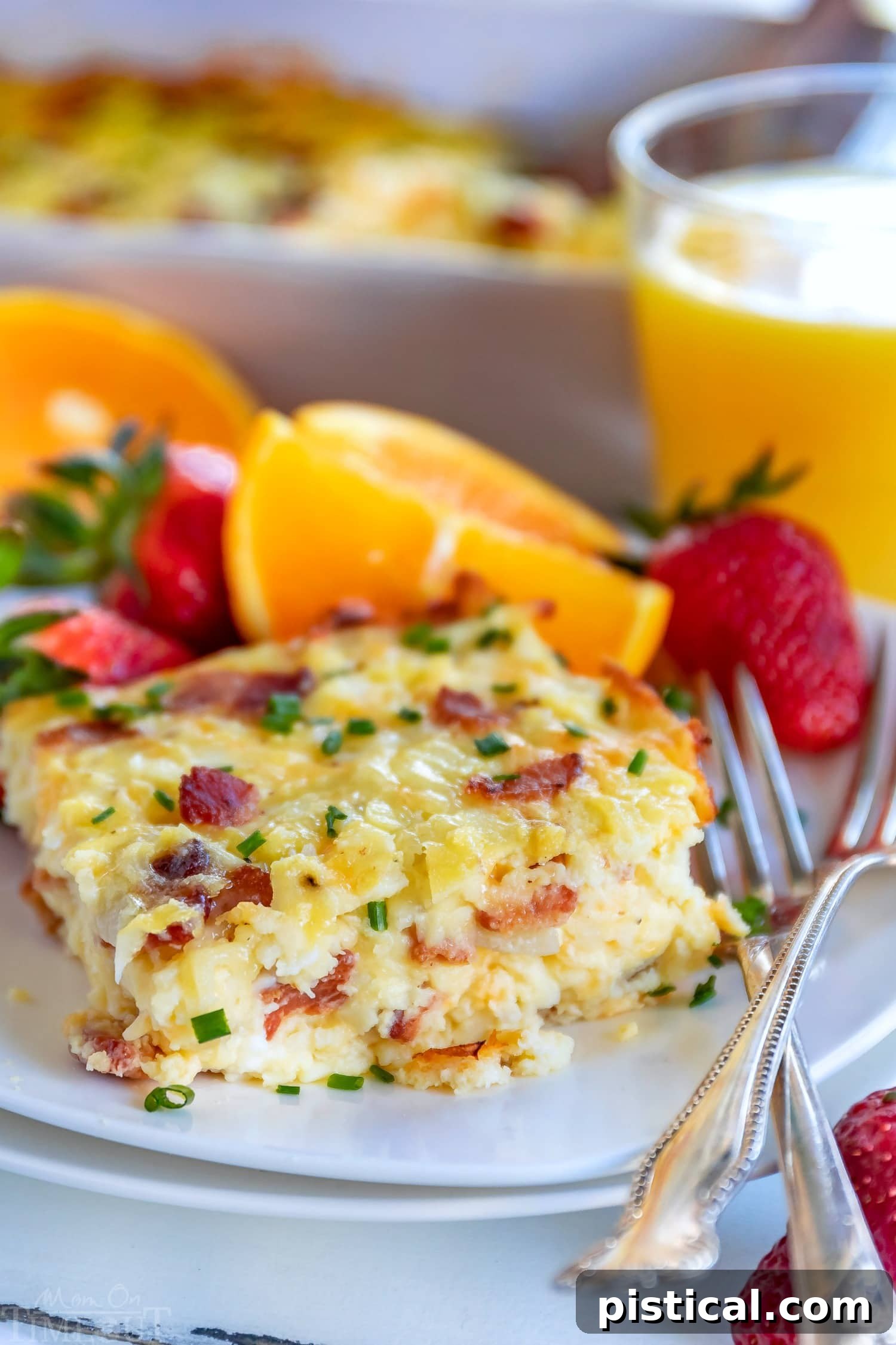A generous serving of easy breakfast casserole on a plate, garnished with fresh chives.