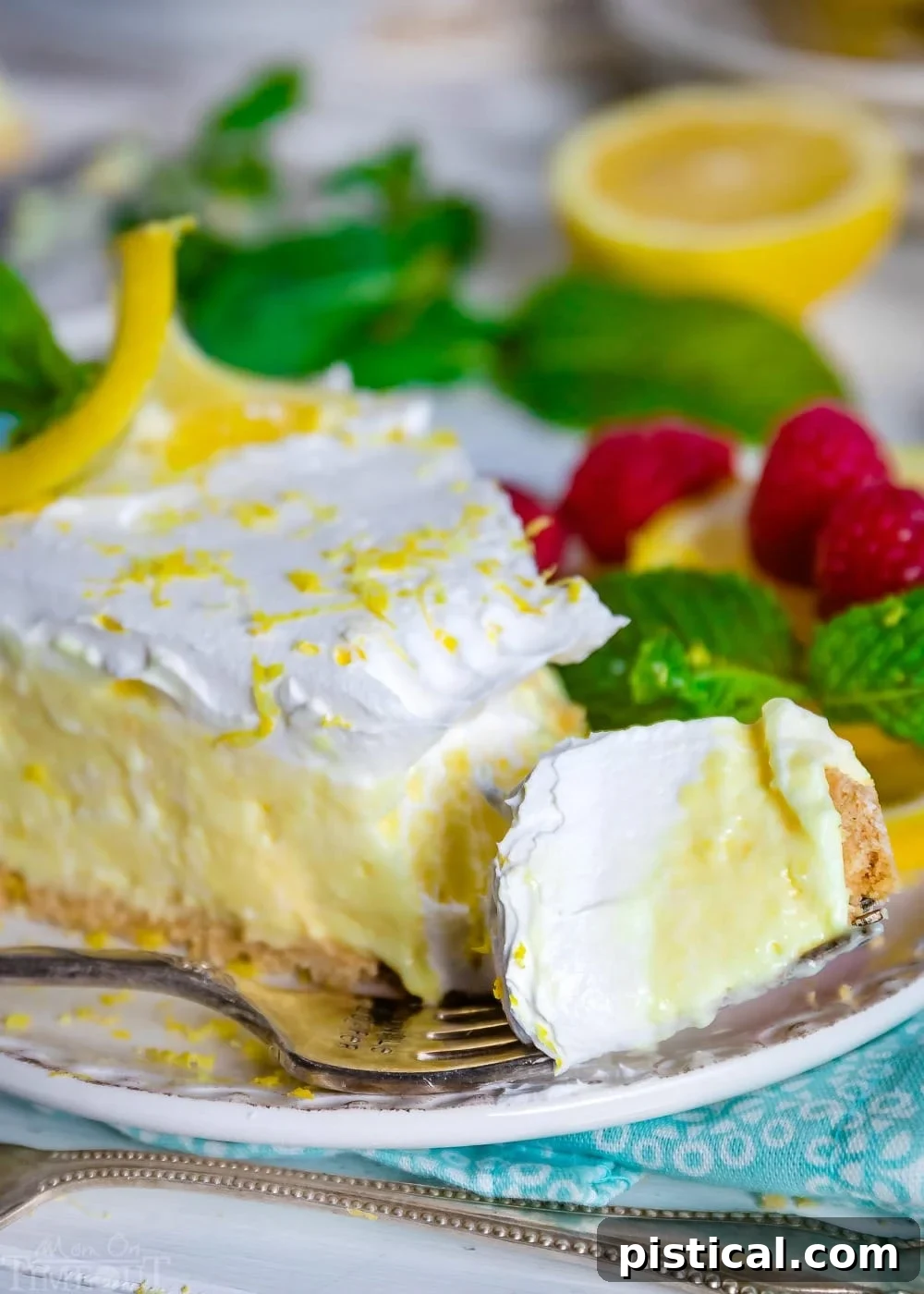 A fork holding a perfect bite of No Bake Lemon Pie, showcasing the smooth filling and the golden crust.