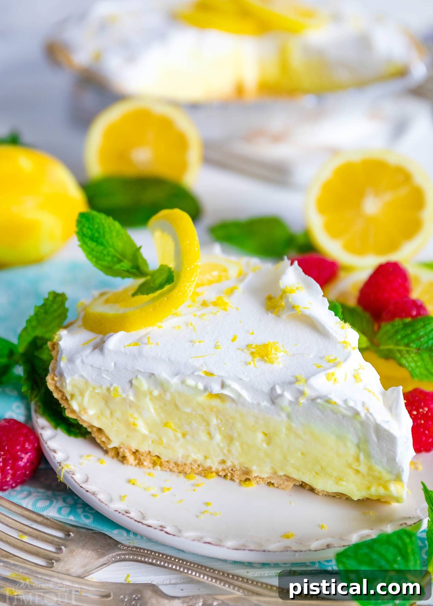 A beautifully decorated No Bake Lemon Pie with a generous swirl of whipped cream topping on a white plate, ready for serving.