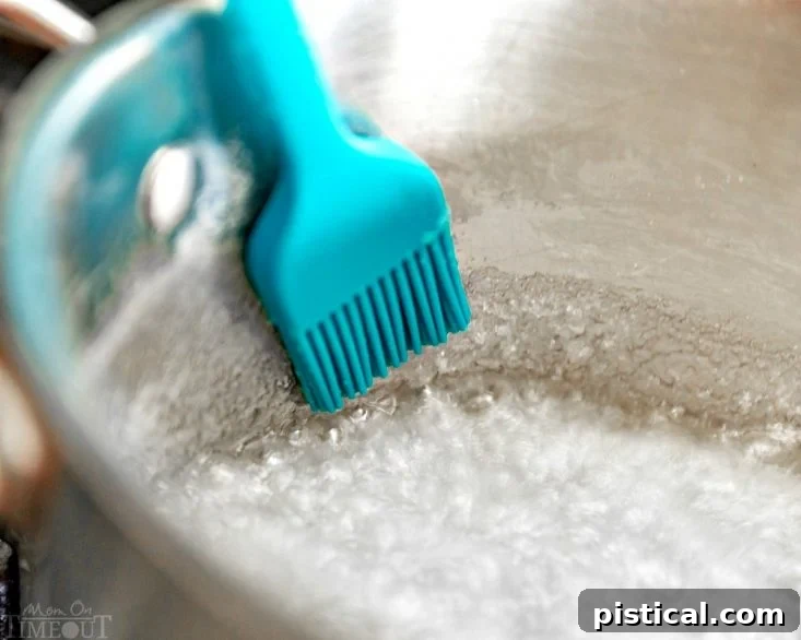 Silicone brush used to clean sugar crystals from the side of a saucepan during caramel making
