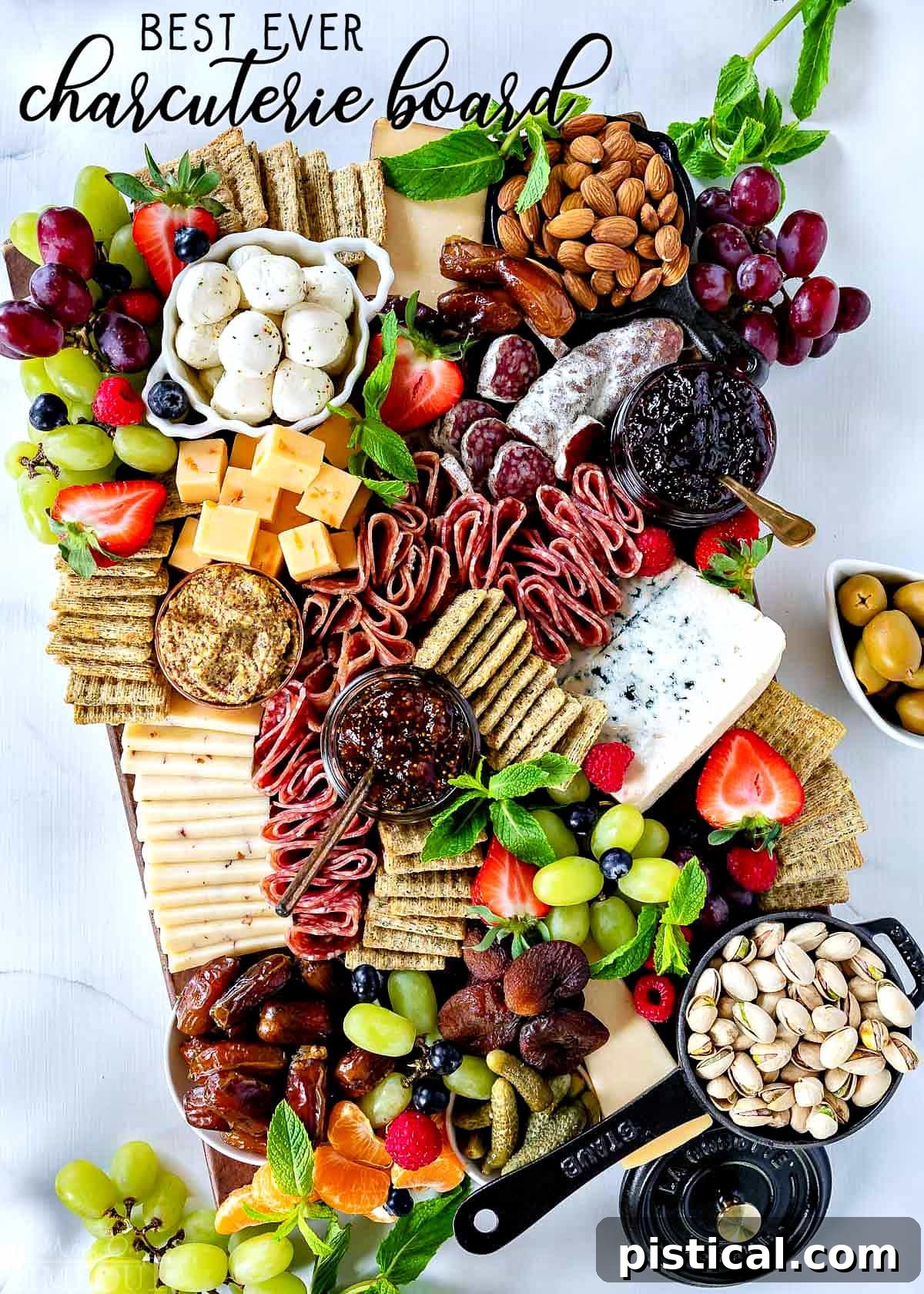 A vibrant and overflowing charcuterie board perfect for entertaining. Impressive charcuterie board with cured meats, cheeses, crackers, fruit, and nuts.