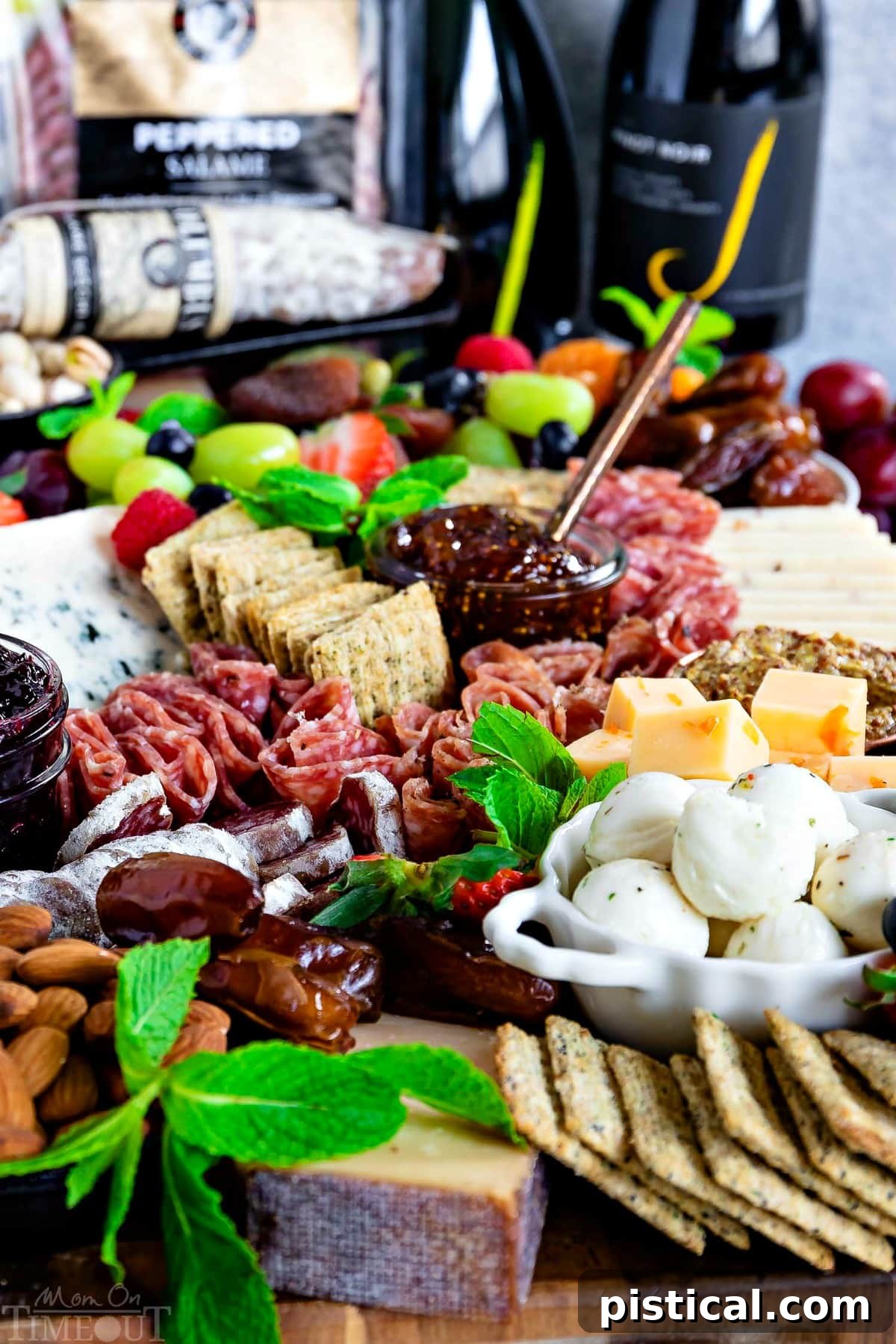A bountiful charcuterie board featuring an array of delectable items. Front view of a fully assembled charcuterie board, ready to serve.