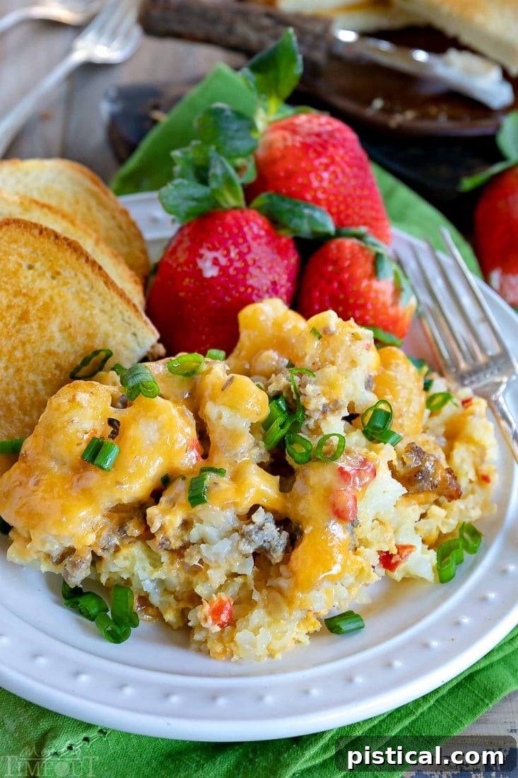 Garnished Slow Cooker Tater Tot Breakfast Casserole, ready to serve. A close-up of the finished Tater Tot Breakfast Casserole with sausage, eggs, cheese, and garnished with fresh green onions.