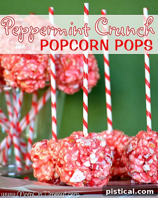 Marshmallow Peppermint Crunch Popcorn Ball Pops ready for a Christmas party, presented on decorative sticks.