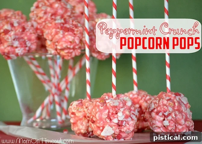 A close-up of a finished Marshmallow Peppermint Crunch Popcorn Ball Pop, showcasing its festive appeal.