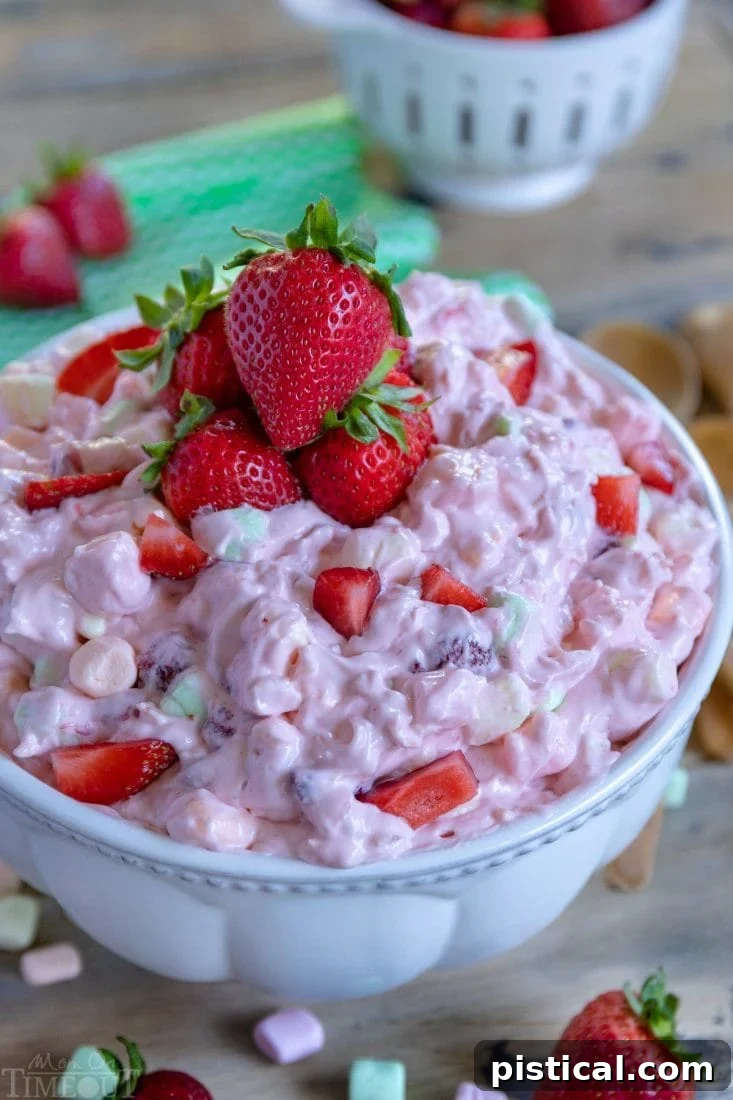 A vibrant bowl of easy Strawberry Fluff, garnished with fresh strawberries, ready for serving at any occasion.