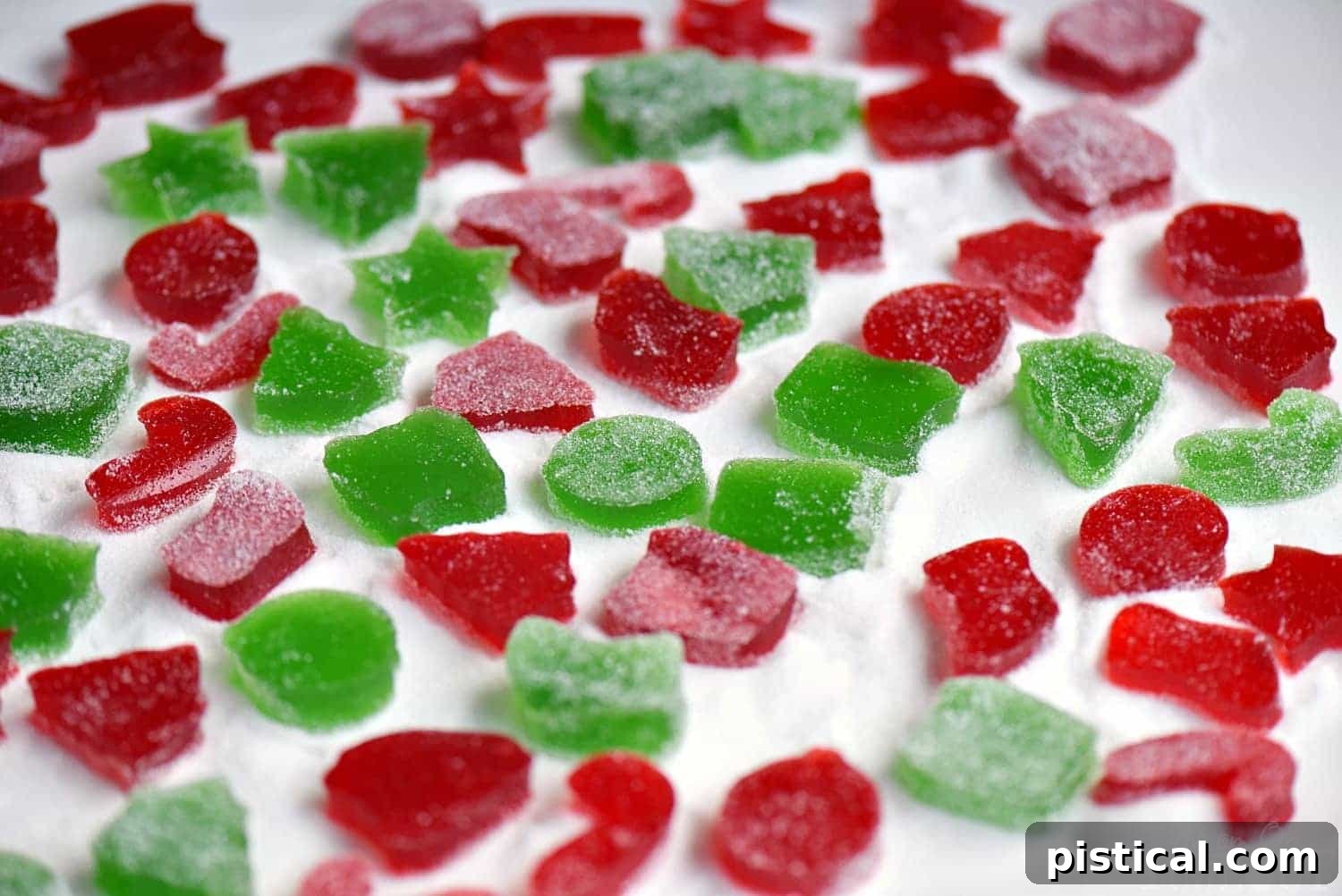 Allow gumdrops to dry overnight before rolling in sugar. gumdrops-drying-on-parchment-paper