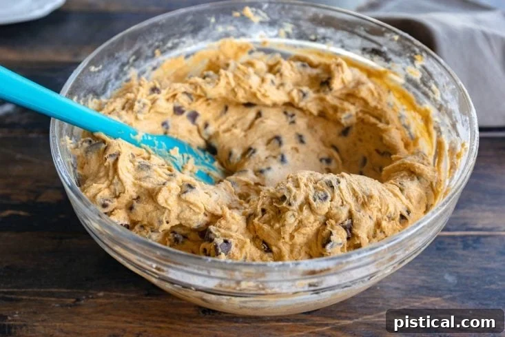 Mixing bowl with pumpkin cake batter being prepared