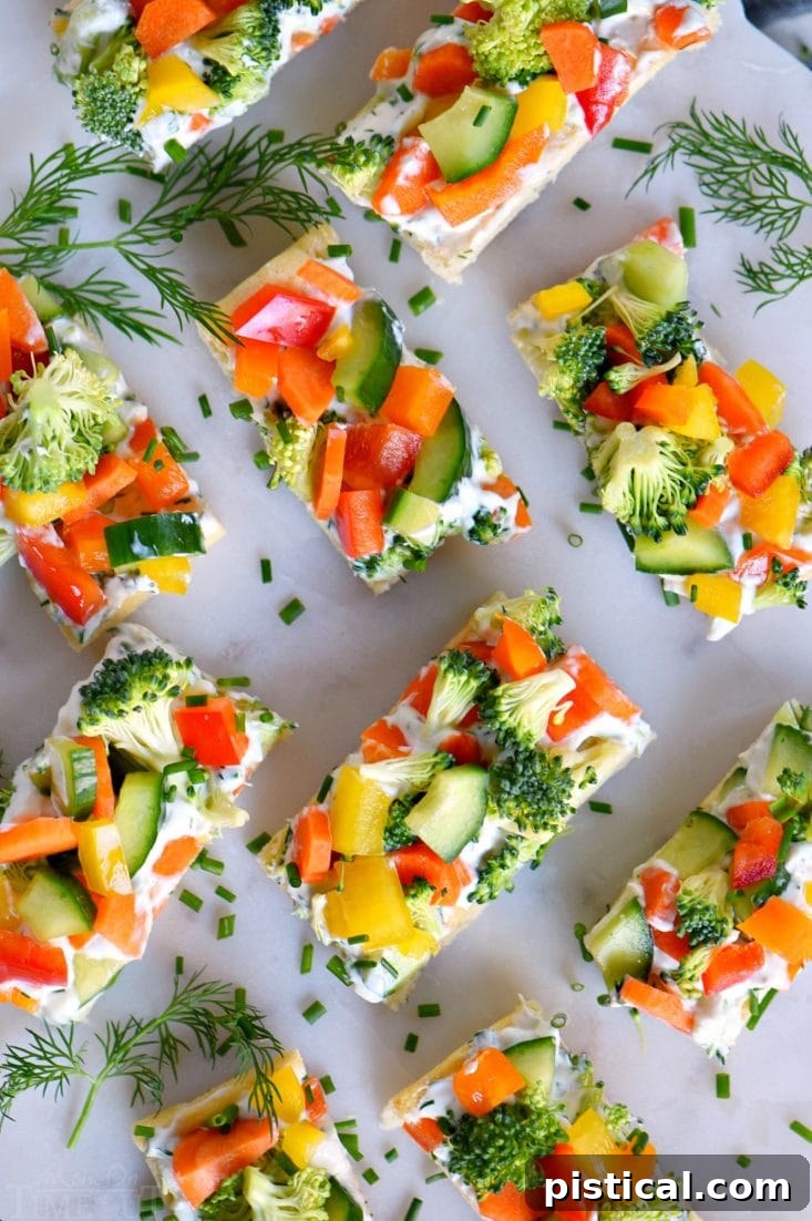 Colorful veggie crescent bites arranged in a zig-zag pattern, showing off their vibrant vegetable filling and flaky crust.