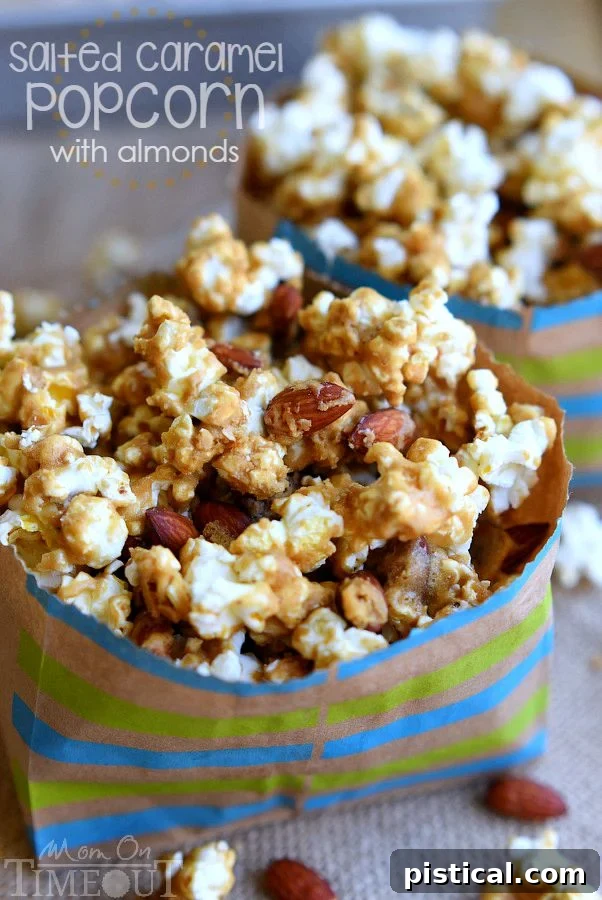 A bowl of glossy salted caramel popcorn with whole almonds, glistening and ready for a sweet and salty snack.