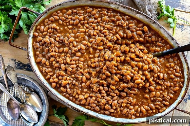A large serving dish overflowing with delicious, easy homemade baked beans, ready for a crowd.