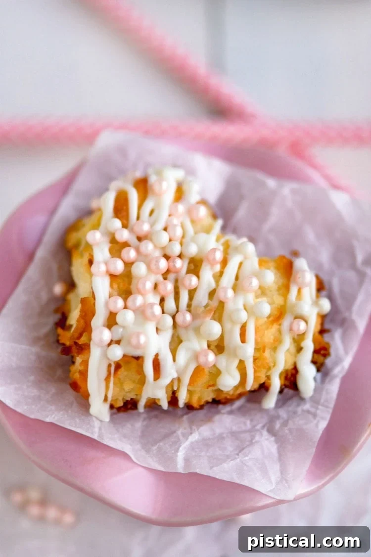 Detailed Valentine's Day Coconut Macaroons recipe displayed on a pink pedestal