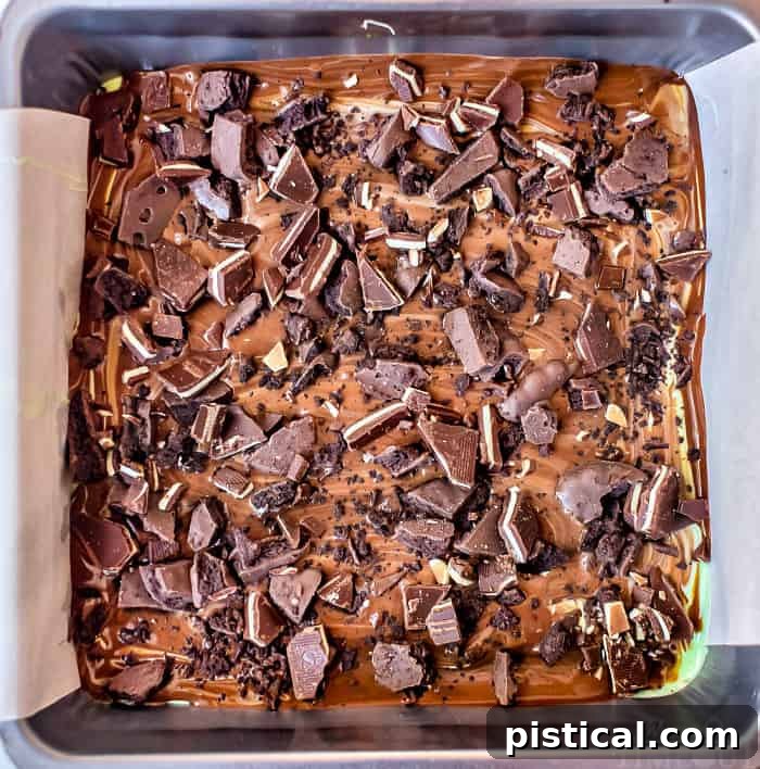 Mint chocolate bark with crushed cookies and mints on top, broken into pieces