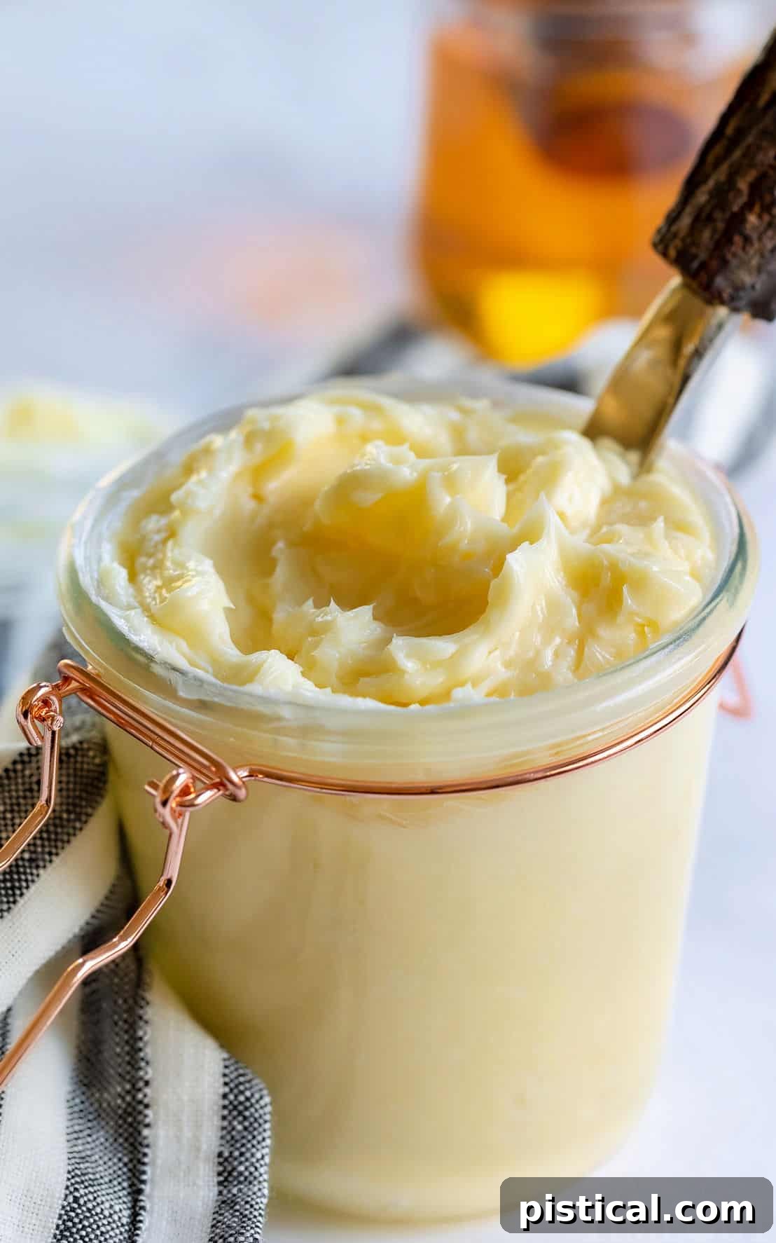 The BEST Honey Butter is ridiculously easy to make and tastes amazing! With just 4 ingredients, this homemade honey butter recipe is perfectly sweet and creamy and is incredible smeared on cornbread, biscuits and homemade dinner rolls! honey butter in jar with lid and towel
