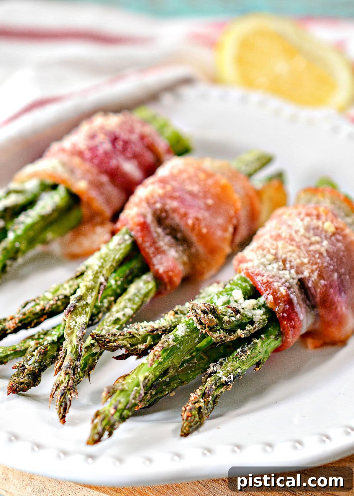 Cooked bacon wrapped asparagus bundles, ready to be served, highlighting oven or air fryer versatility.