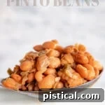 Pinto beans recipe served in a spoon over a white crockpot with text overlay