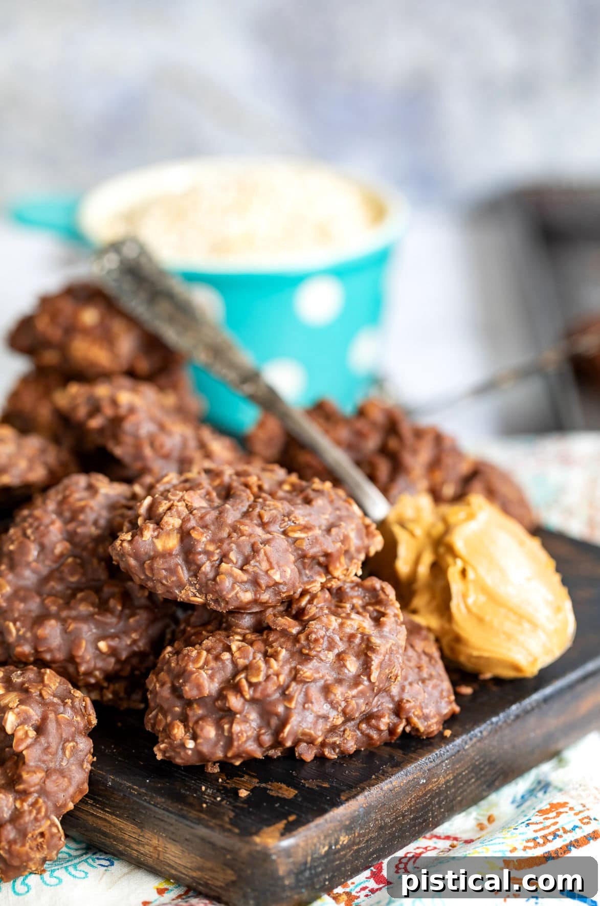 Effortless No-Bake Delights 7 chocolate no bake cookies on cutting board with a spoonful of peanut butter