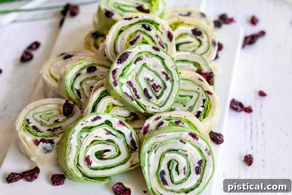 turkey pinwheels stacked high on a white cutting board