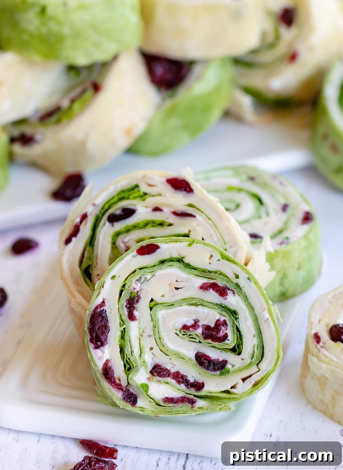 turkey pinwheels recipe with dried cranberries on small white board