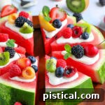 Delicious watermelon pizza with cream cheese glaze and fresh fruit toppings