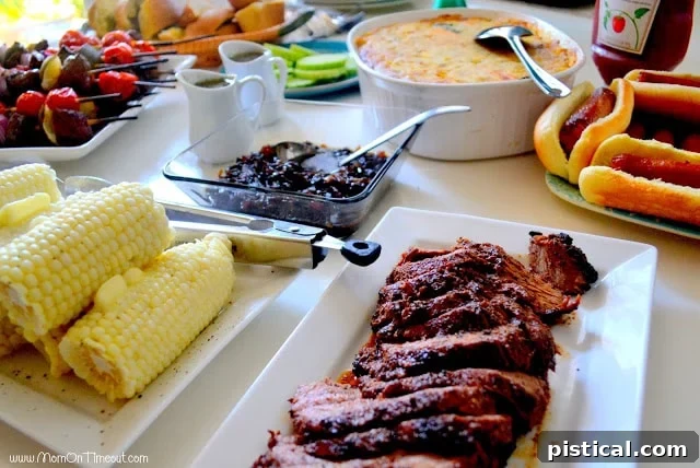 A vibrant table spread of grilled dishes and side salads, ready for a backyard party.