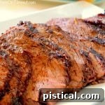beef tri tip sliced on white plate