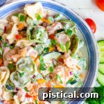 Tortellini Pasta Salad in a blue-rimmed bowl