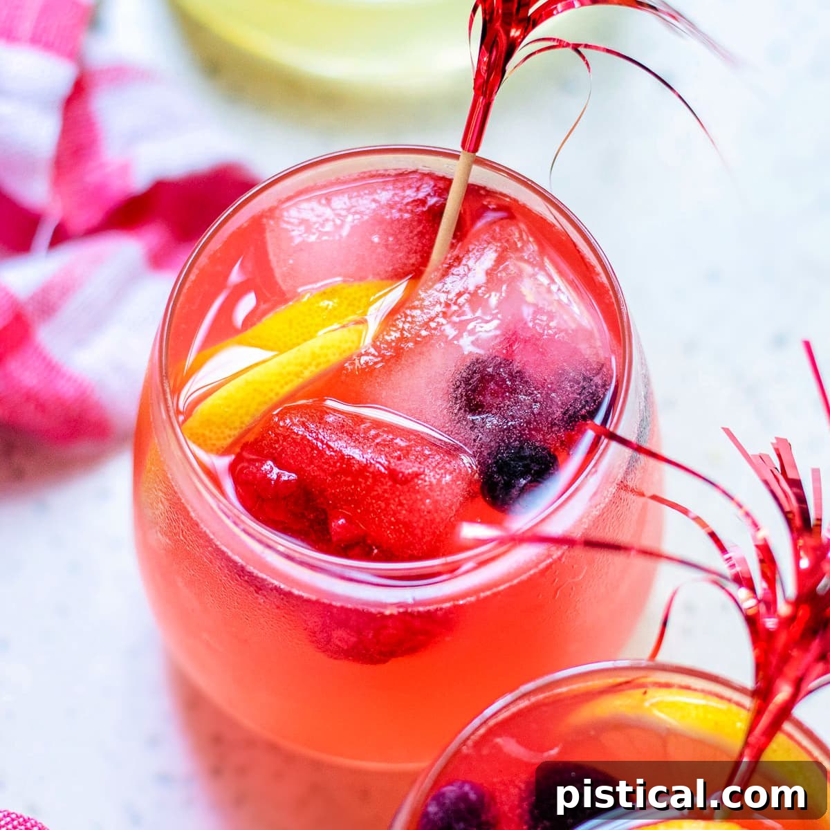 Top-down view of two wine glasses filled with Berry Lemonade, showcasing its vibrant color and fresh appeal.