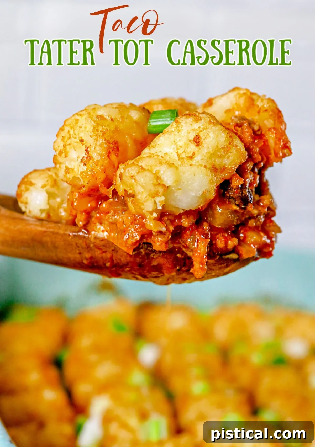 A large wooden spoon scooping a generous portion of hot, bubbling Taco Tater Tot Casserole from a white baking dish, showcasing crispy golden tater tots and a rich, cheesy filling. The background is softly blurred, emphasizing the deliciousness of the dish.