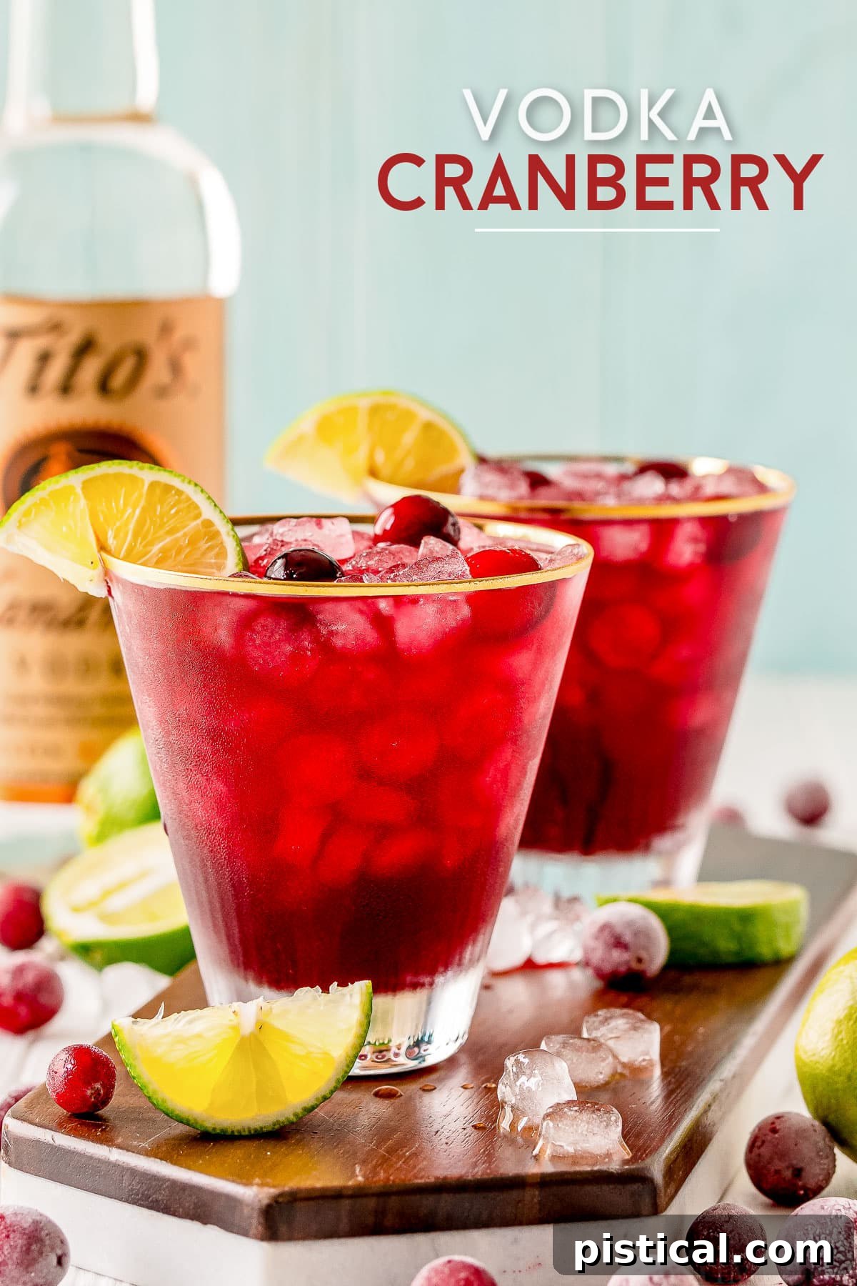 vodka cranberry recipe in two glasses with lime wedges and cranberries vodka bottle in background