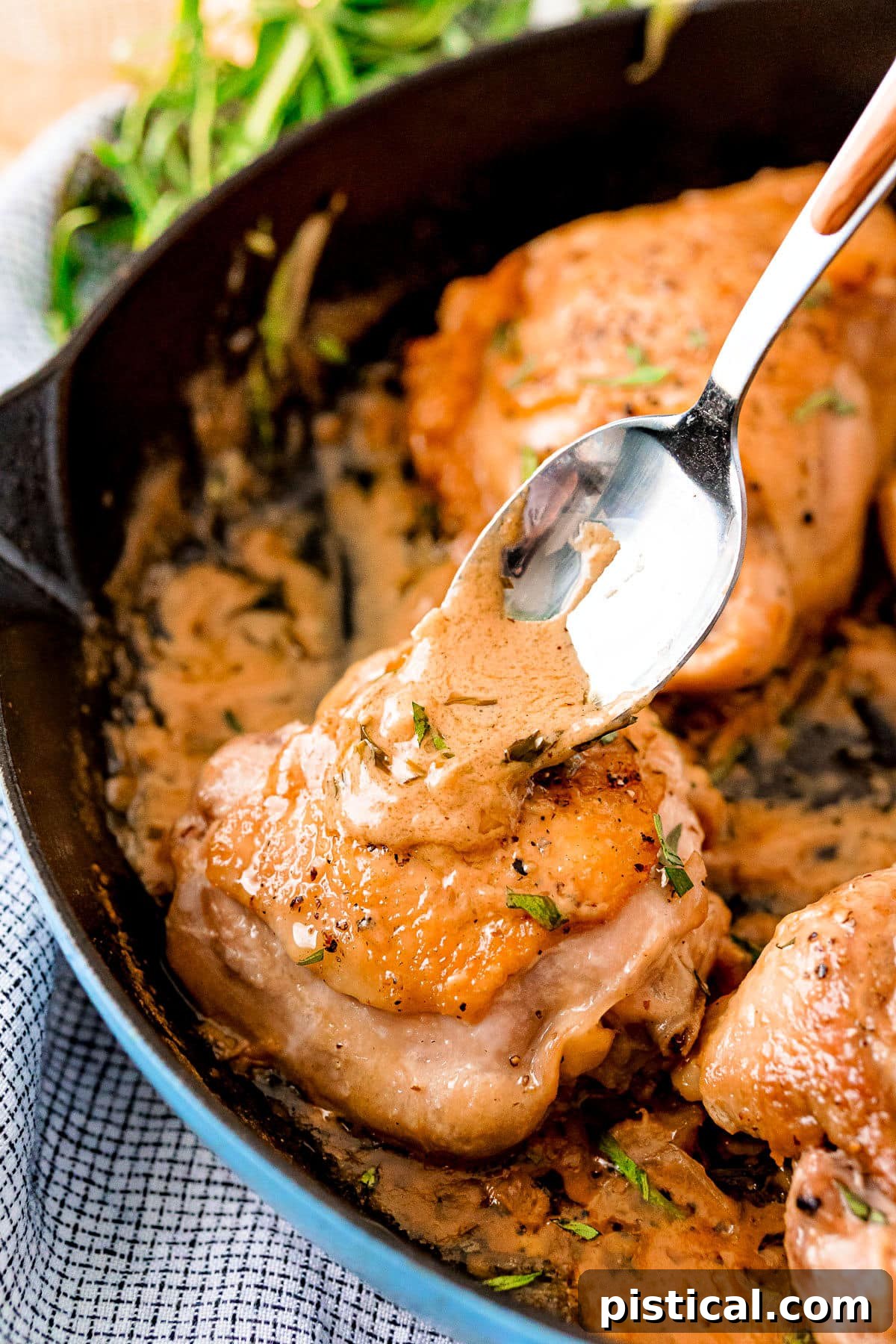 Velvety Mustard Chicken Bake 4 mustard sauce being spooned onto chicken thigh in skillet