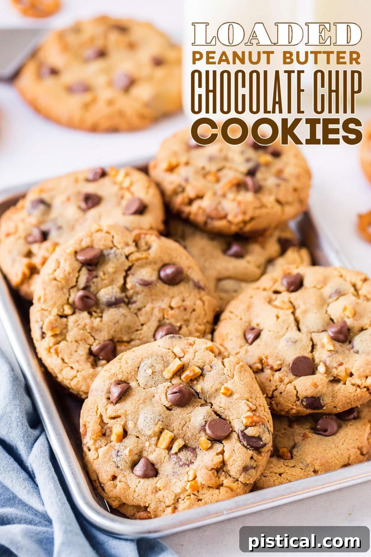 A delectable pile of Loaded Peanut Butter Chocolate Chip Cookies showcased in an eighth sheet pan with a blue napkin nearby, text overlay at the top.