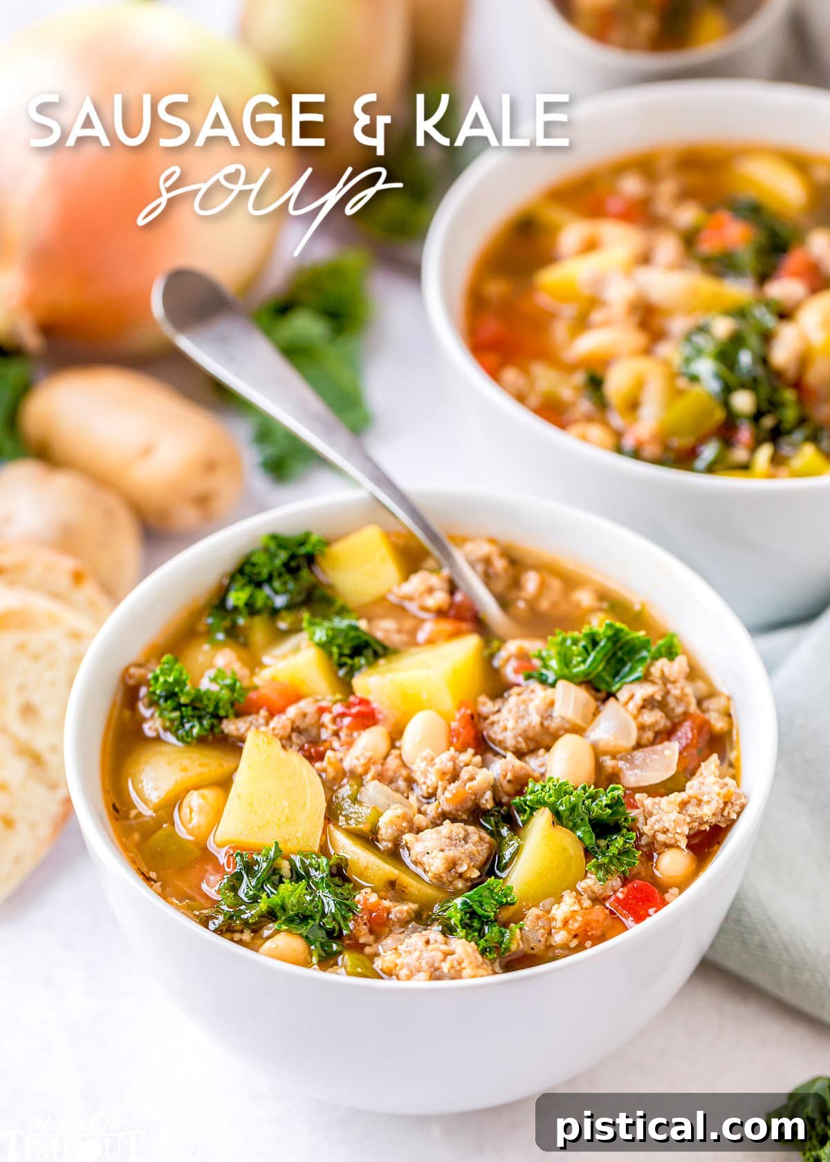 A steaming bowl of hearty Sausage Kale Soup with a spoon, ready to be enjoyed. Another bowl sits invitingly in the background, suggesting a comforting meal.