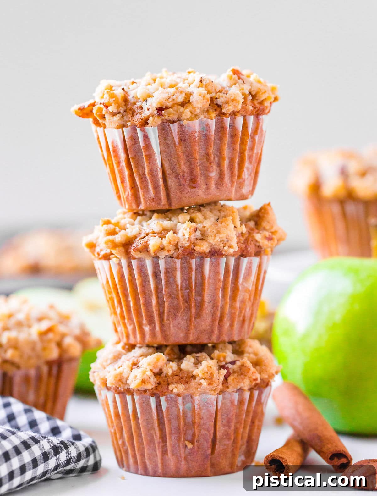 apple muffins-stacked three high with more muffins in background