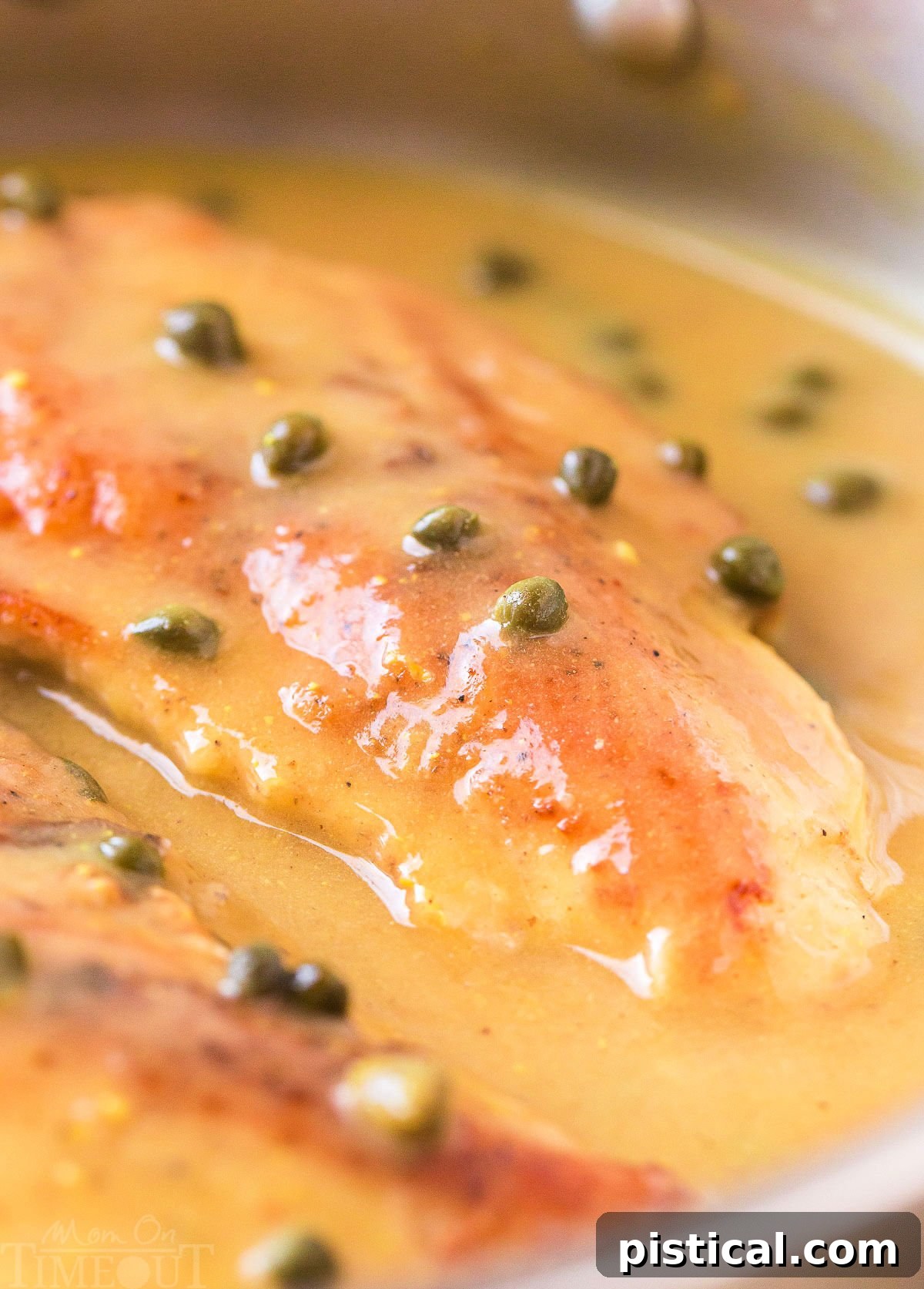 chicken piccata in a skillet with lemon caper sauce ready to be served.