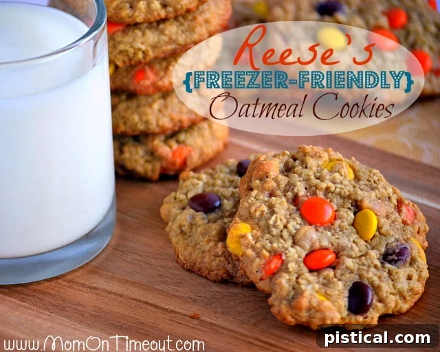 Freshly baked Reese's Oatmeal Cookies cooling on a rack, showcasing their chewy texture and colorful Reese's Pieces.