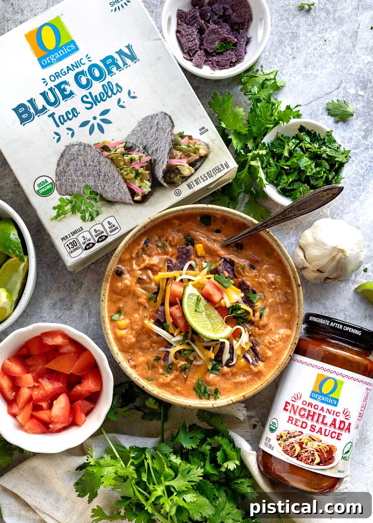 chicken enchilada soup top down view with toppings in bowls and two ingredient pagackages