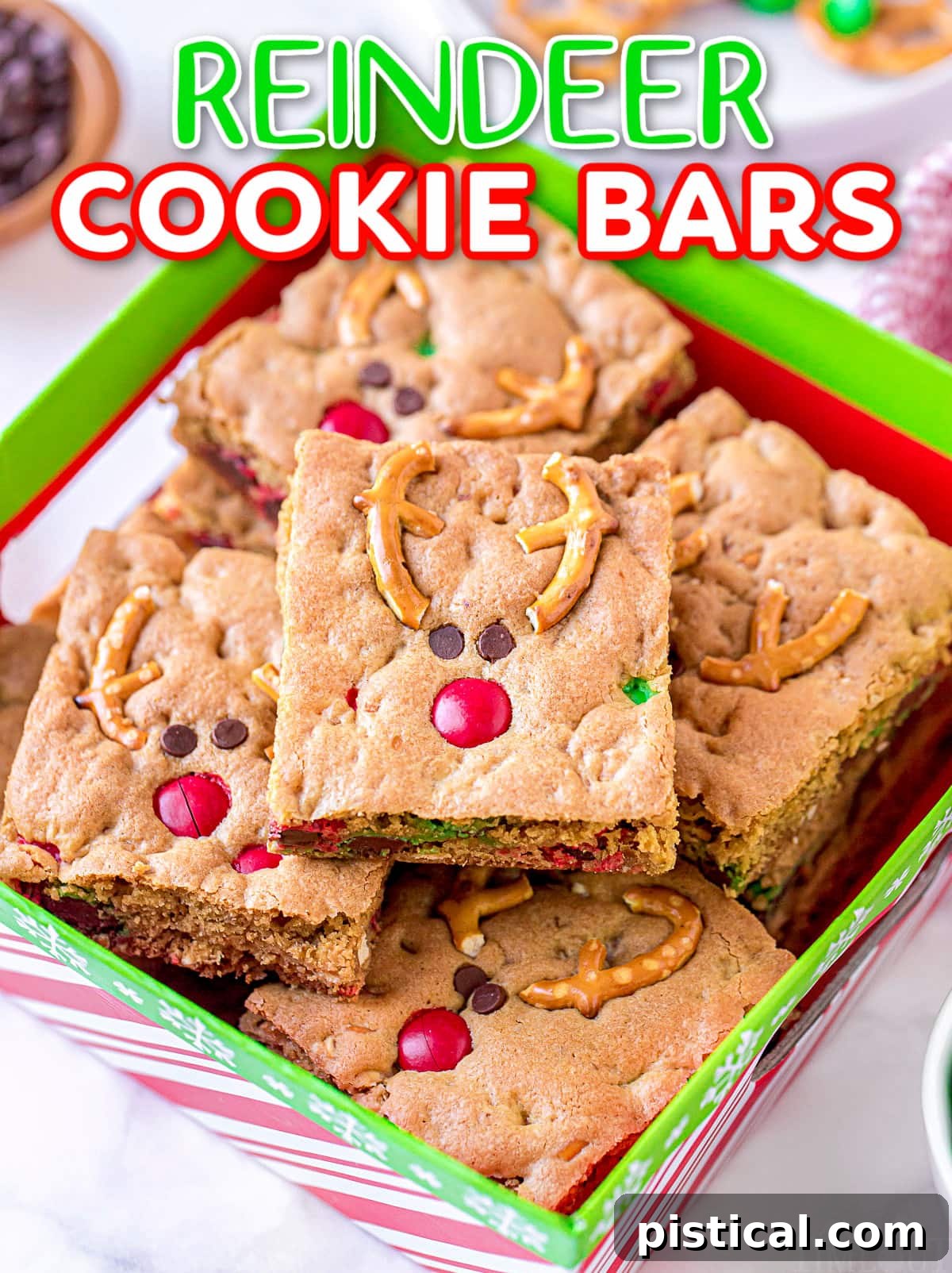 Stacked Reindeer Cookie Bars in a festive red and green Christmas box, showcasing their cute decoration