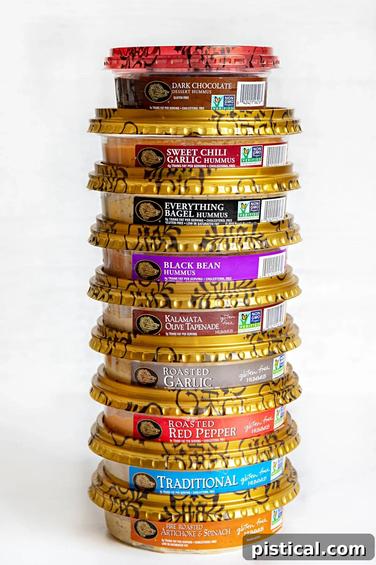 Various containers of Boar's Head hummus stacked neatly on a white surface, highlighting a range of delicious flavors.