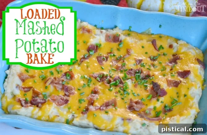 Close-up of rich and flavorful Loaded Mashed Potato Bake with cheese and chives.